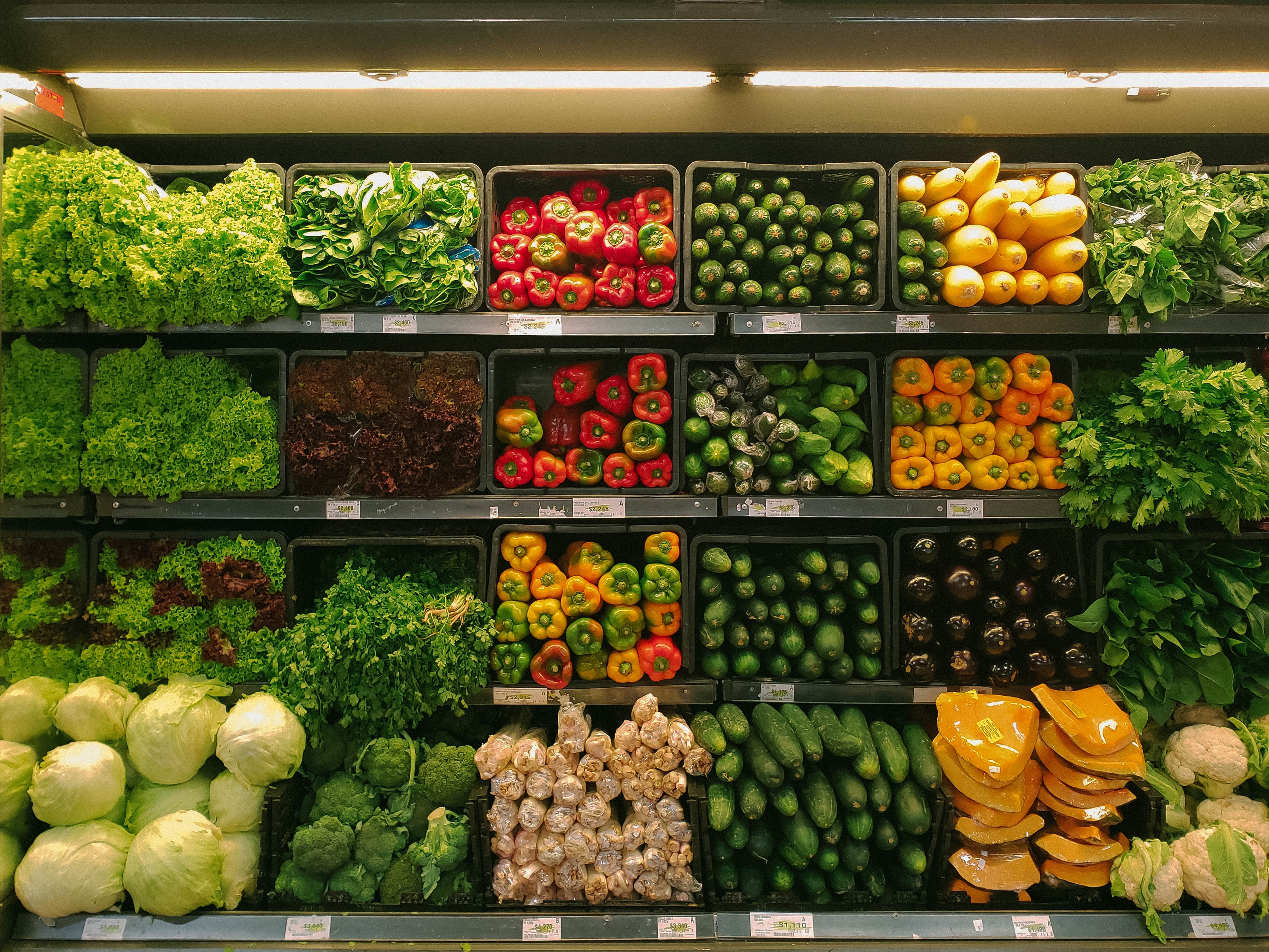 vegetables and fruit on a shelf in a grocery store