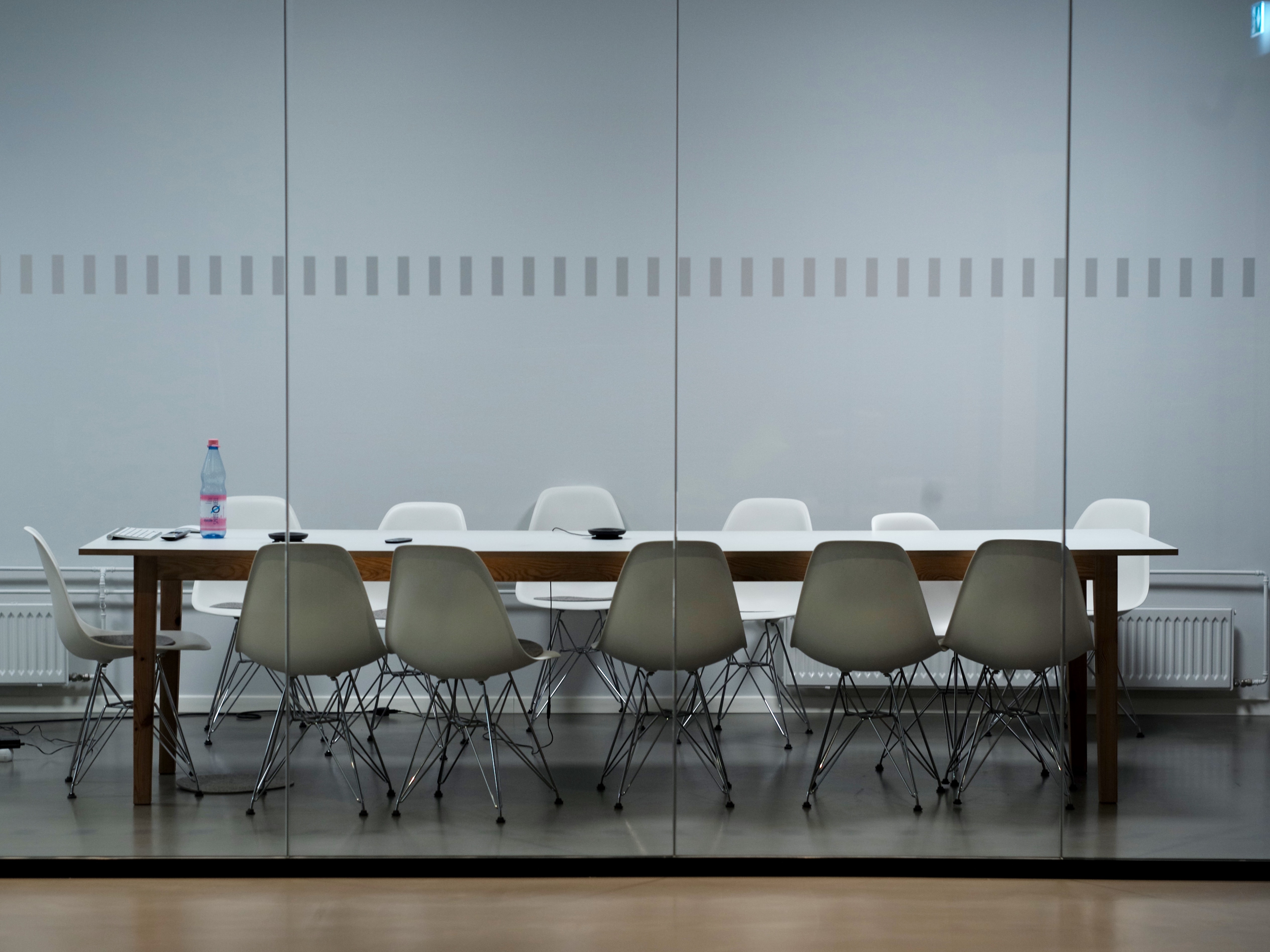 image of an office space with white chairs around a table